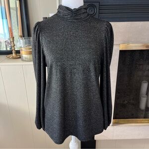 Shimmery black mock neck top with puffy sleeves